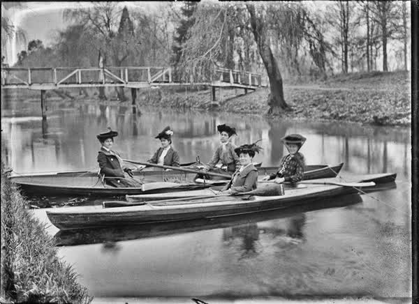 Five women in canoes and rowboats on the Avon River, 1900