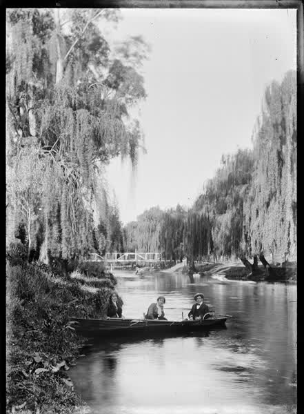 Two women and a man in a double rowboat on the Avon River, 1900