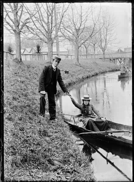 Woman in a rowboat by the Antigua Boat Sheds, 1900