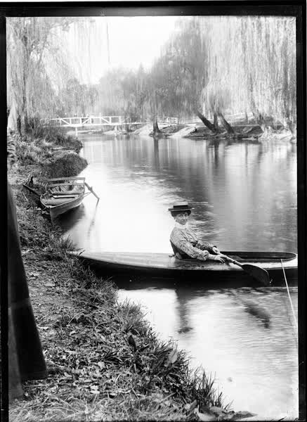 Woman in a tethered canoe on the Avon River, 1900