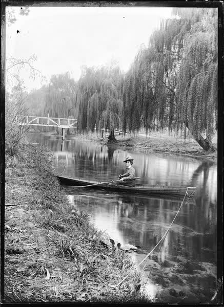 Woman in a tethered rowboat on the Avon River, 1900
