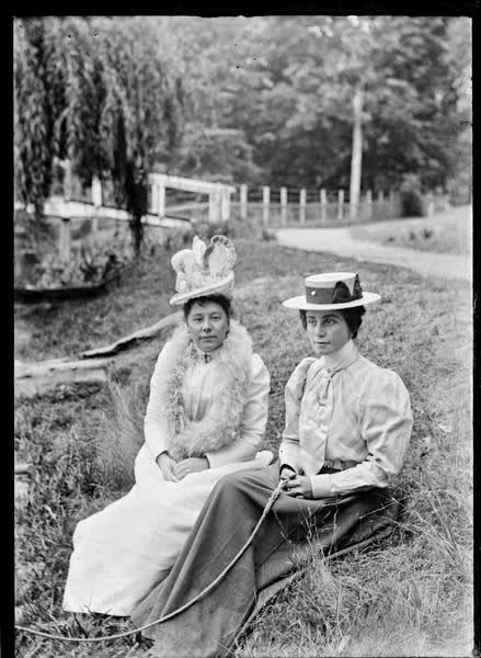 Two women seated on the bank of the Avon River, 1900