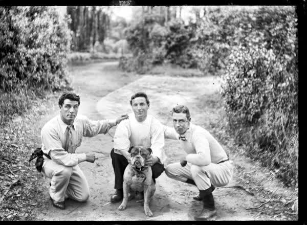 Three men and a bulldog, 1900