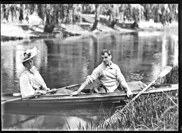 Man and woman in a double canoe on the Avon River, 1900