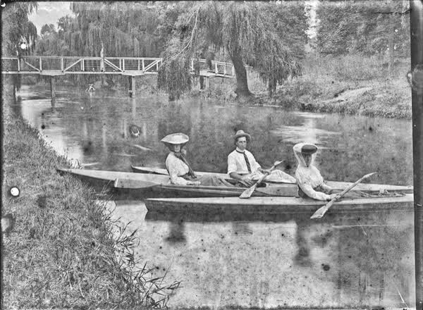 Two women and a man in canoes on the Avon River, 1900
