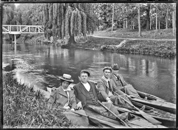 Three men and a woman in canoes on the Avon River, 1900