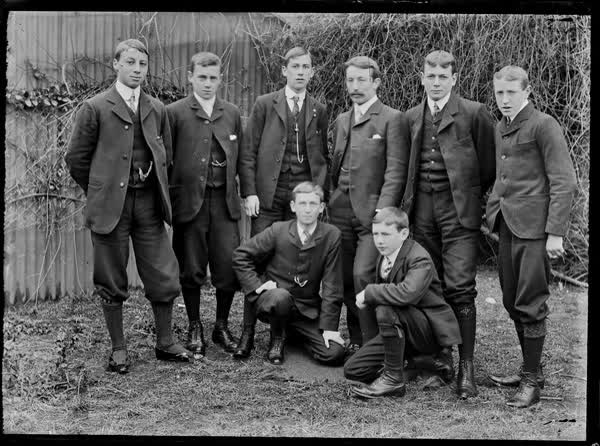 Group of men in a garden, 1900