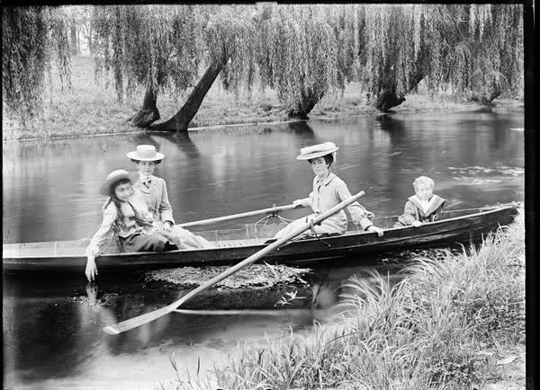 Two women, a girl and a boy in a rowboat on the Avon River, 1900