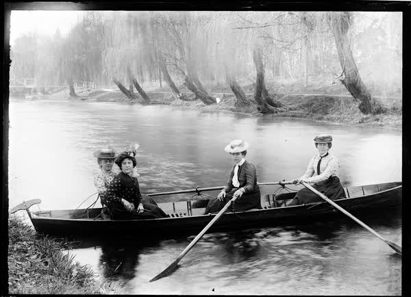 Four women in a double rowboat, 1900