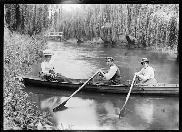 Two women and a man in a double rowboat on the Avon River, 1900