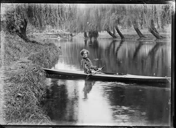 Woman in a tethered canoe on the Avon River, 1900