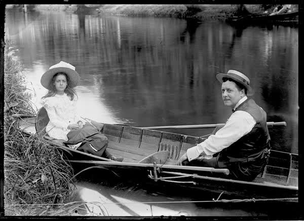 Man and a girl in a tethered rowboat on the Avon River, 1900