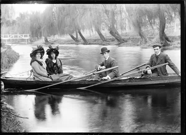 Two women and two men in a double rowboat on the Avon River, 1900