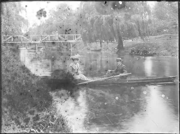 Man and woman in a tethered rowboat on the Avon River, 1900