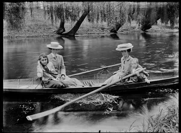 Two women with a boy and a girl on the Avon River, 1900