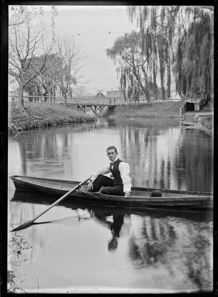 Man in a canoe by the Antigua Bridge, 1900