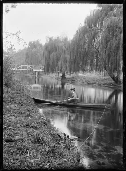 Woman in a tethered rowboat on the Avon River, 1900