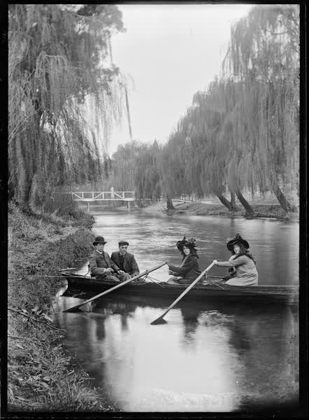Two women and two men in a double rowboat on the Avon River, 1900