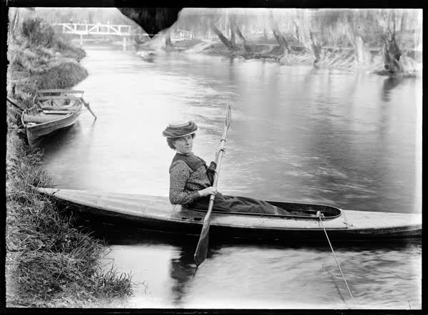 Woman in a tethered canoe on the Avon River, 1900