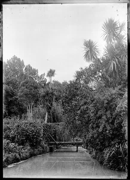 Stream or small river with small footbridge, 1900