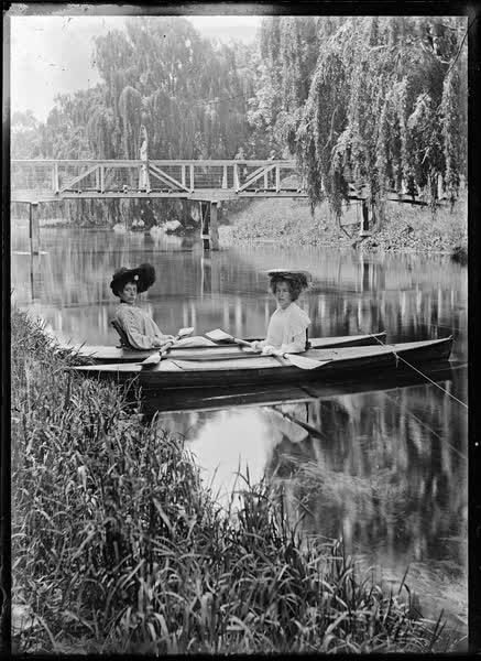 Two women in tethered canoes on the Avon River, 1900