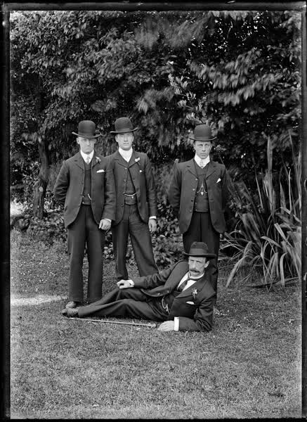 Three men standing and one man reclining, 1904