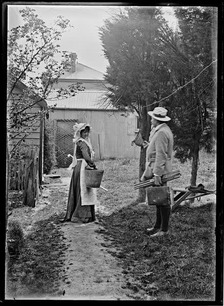 Man and woman on a garden path, 1900