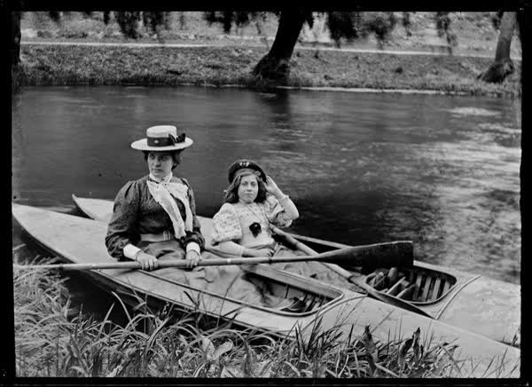 Woman and a girl in canoes on the Avon River, 1900