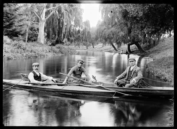 Three men in a rowboat and a canoe, 1900
