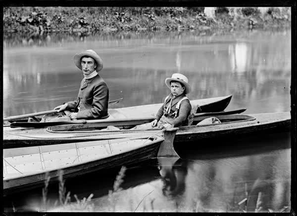 Man and boy in canoes on the Avon River, 1900