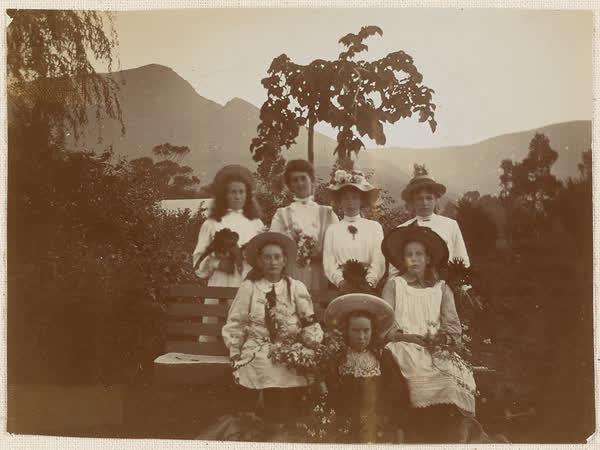 Miss Mouldey and group of girls holding flowers, 1910