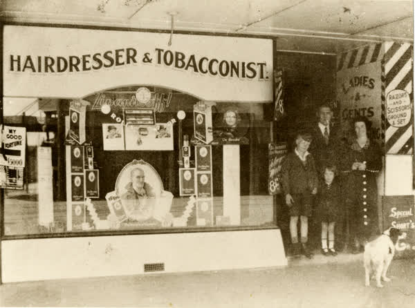 Albert Grundy and family outside their shop, 1935