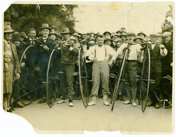Thomas Marker competing in bicycle race, 1880