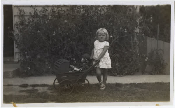 Connie Macefield with a wooden doll pram, 1933
