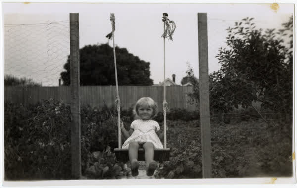 Connie Macefield on a swing, 1933