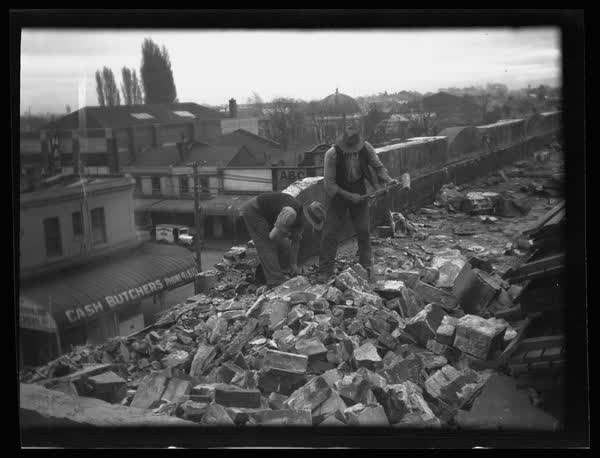 Demolition workers on roof, 1937