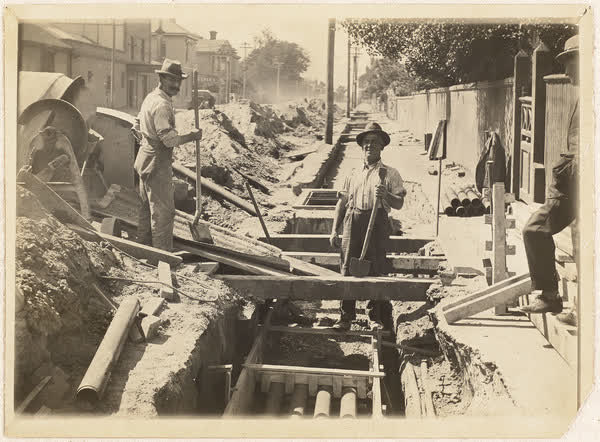 Workers filling trench on Armagh Street, 1920