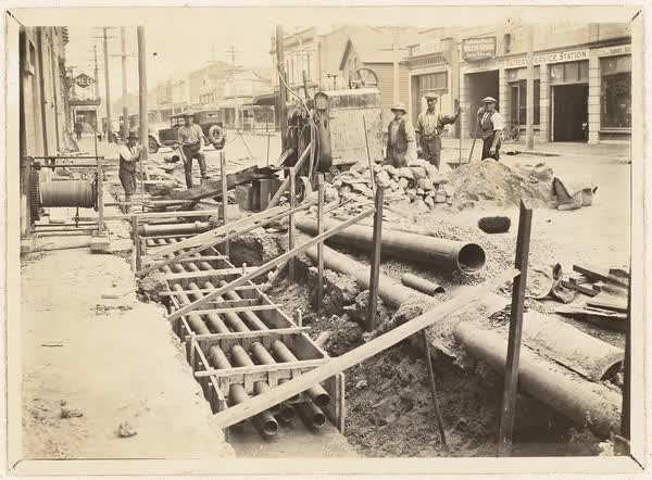 Workers pose with fibre ducts, 1920