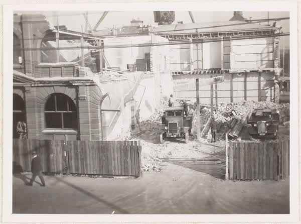 Workers and trucks on MED demolition site, 1937
