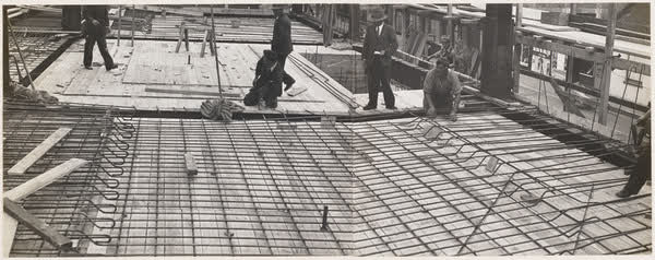 Workers laying out reinforcing for floor, 1938
