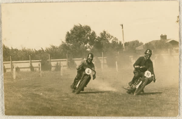 Two motorcyclists cornering a bend at New Brighton Racecourse, 1920