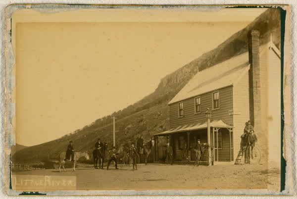 Nine unidentified men in front of Little River Hotel, 1886