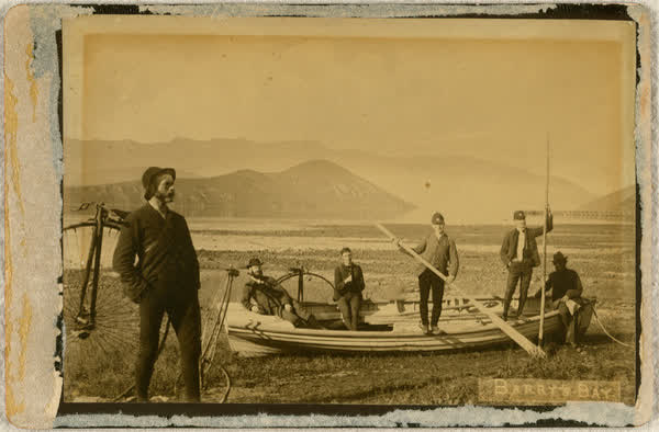 Six men with a bike and a boat in Barry’s Bay, 1886