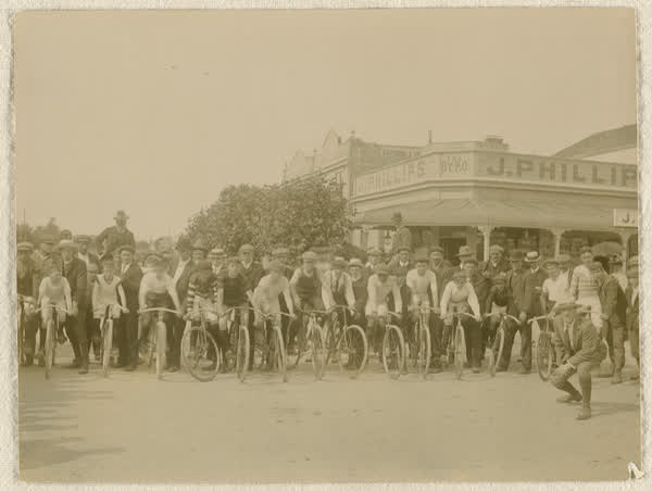 Group of unidentified men and boys with bicycles, 1910