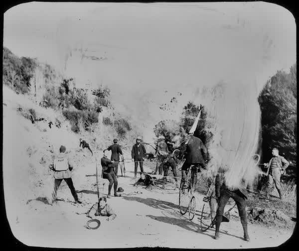 Thirteen unidentified men climbing the hill to Akaroa, 1886