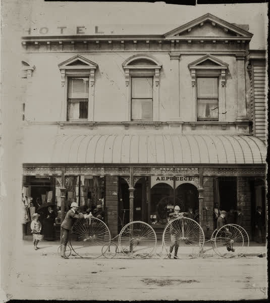 Eleven people outside A. E. Preece’s Cyclists’ Exchange, 1885