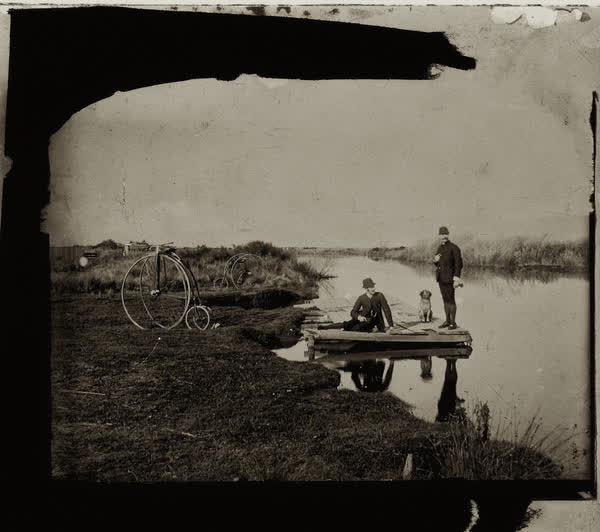 H. J. Parker and Charles August Myhre with a dog at the Avon River, 1885