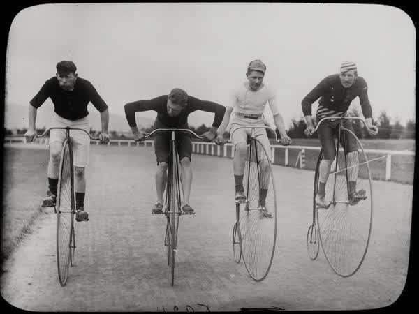 Four men on penny-farthings at Lancaster Park, 1890