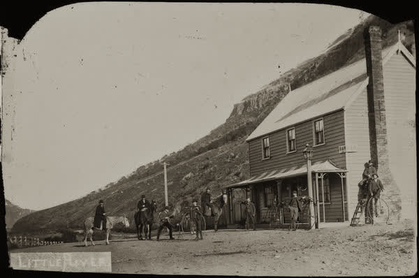 Nine unidentified men in front of Little River Hotel, 1886