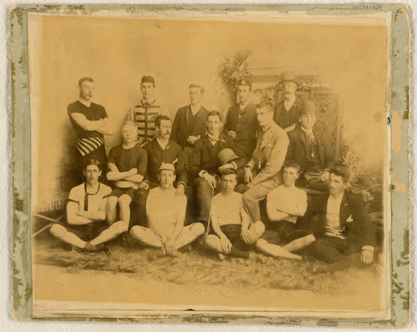Fifteen unidentified men in a garden themed studio, 1889